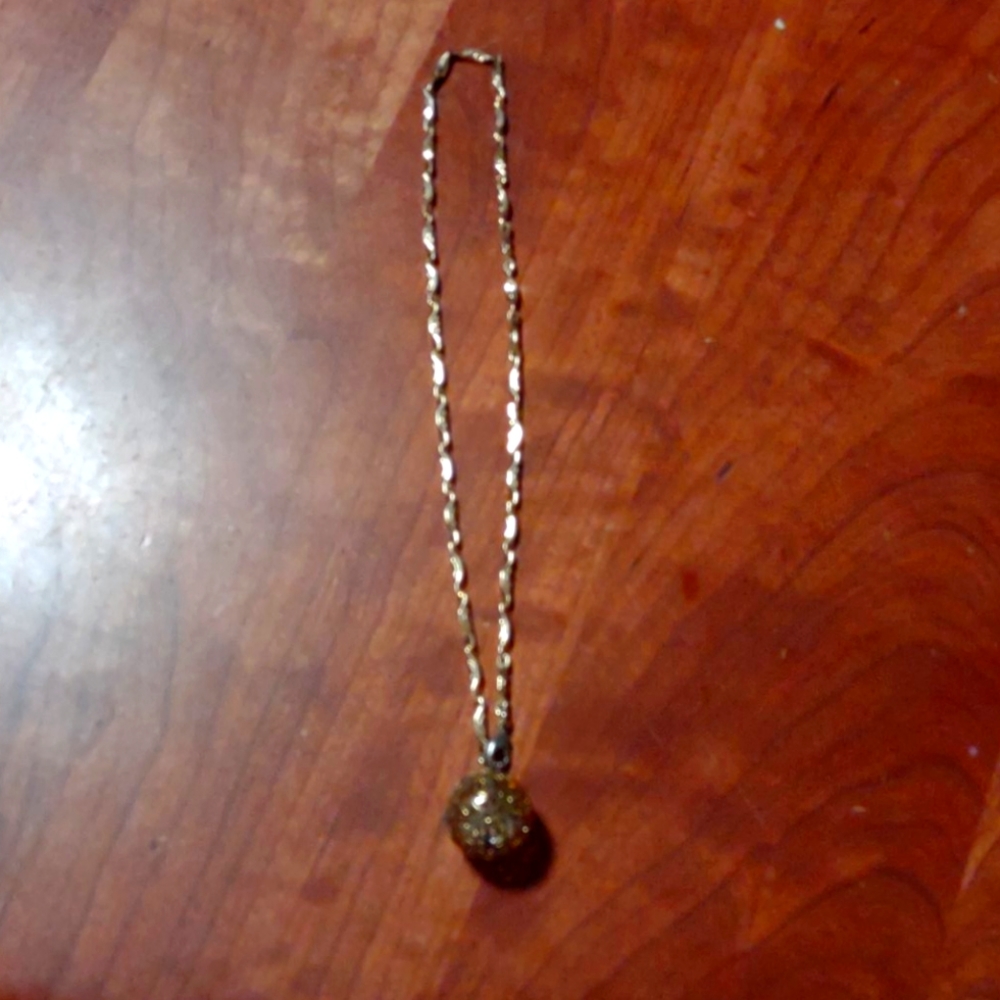 Gold colored chain with ball